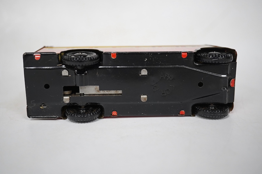 A boxed Wells Brimtoy tinplate clockwork trolley bus loosely in London Transport livery, together with three keys. Condition fair to good, clockwork motor appears to work correctly although has lost grip on the driving a